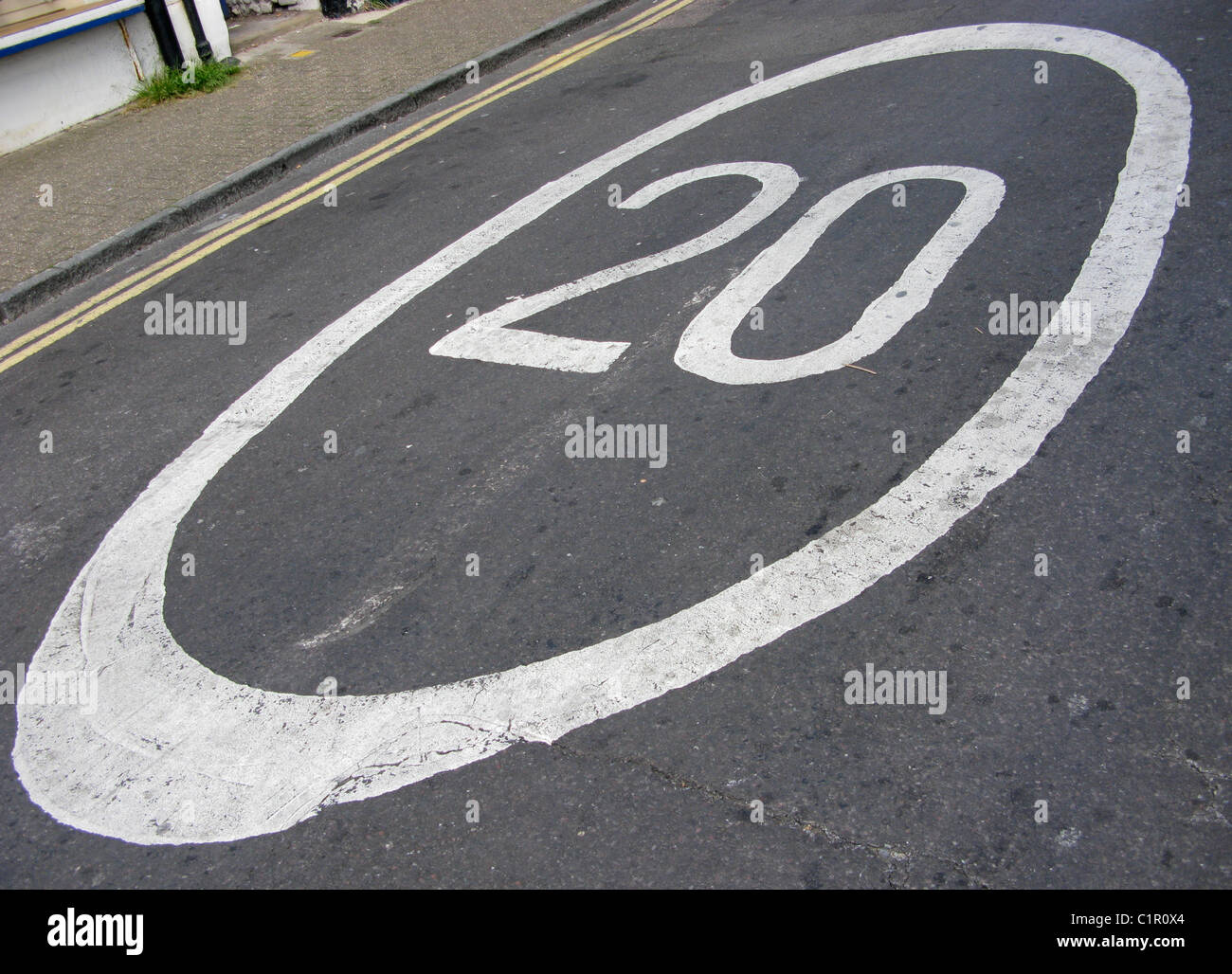 20 mile an hour sign in road to calm the speed of traffic Stock Photo