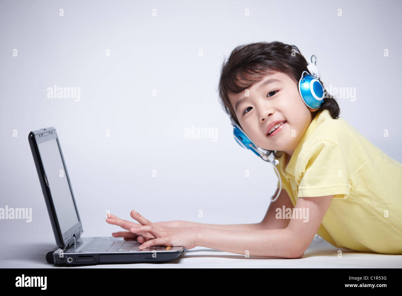 children education boy wearing headphone with laptop Stock Photo - Alamy