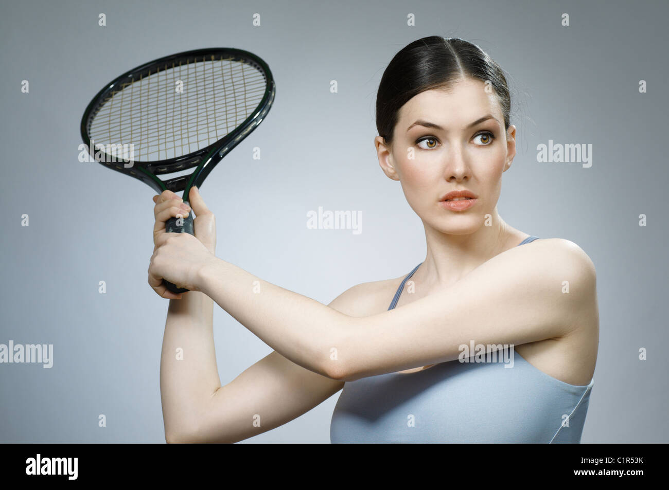 Beautiful sporty girl playing tennis very passionately Stock Photo