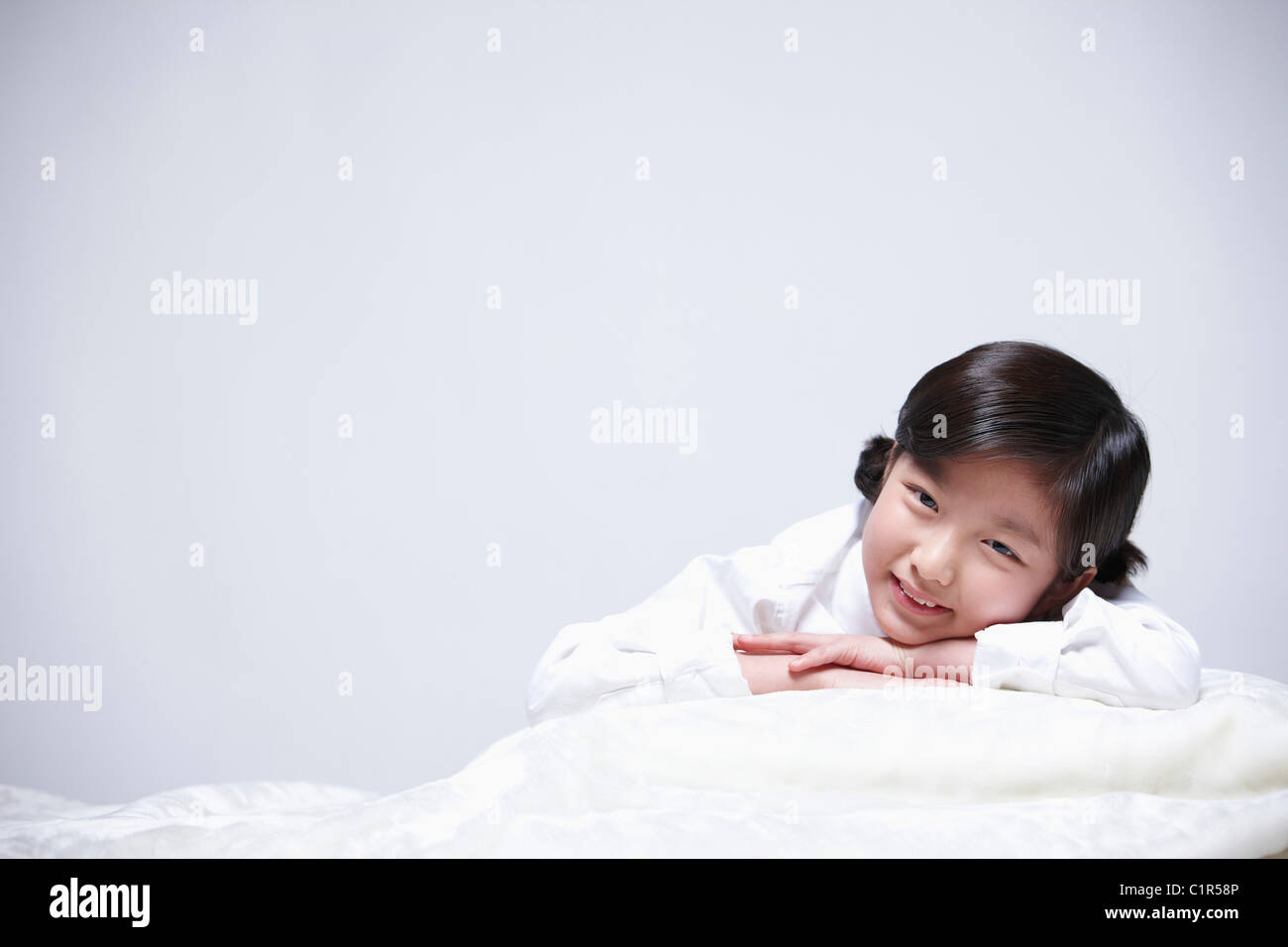 children education girl lay face down on bed Stock Photo Alamy