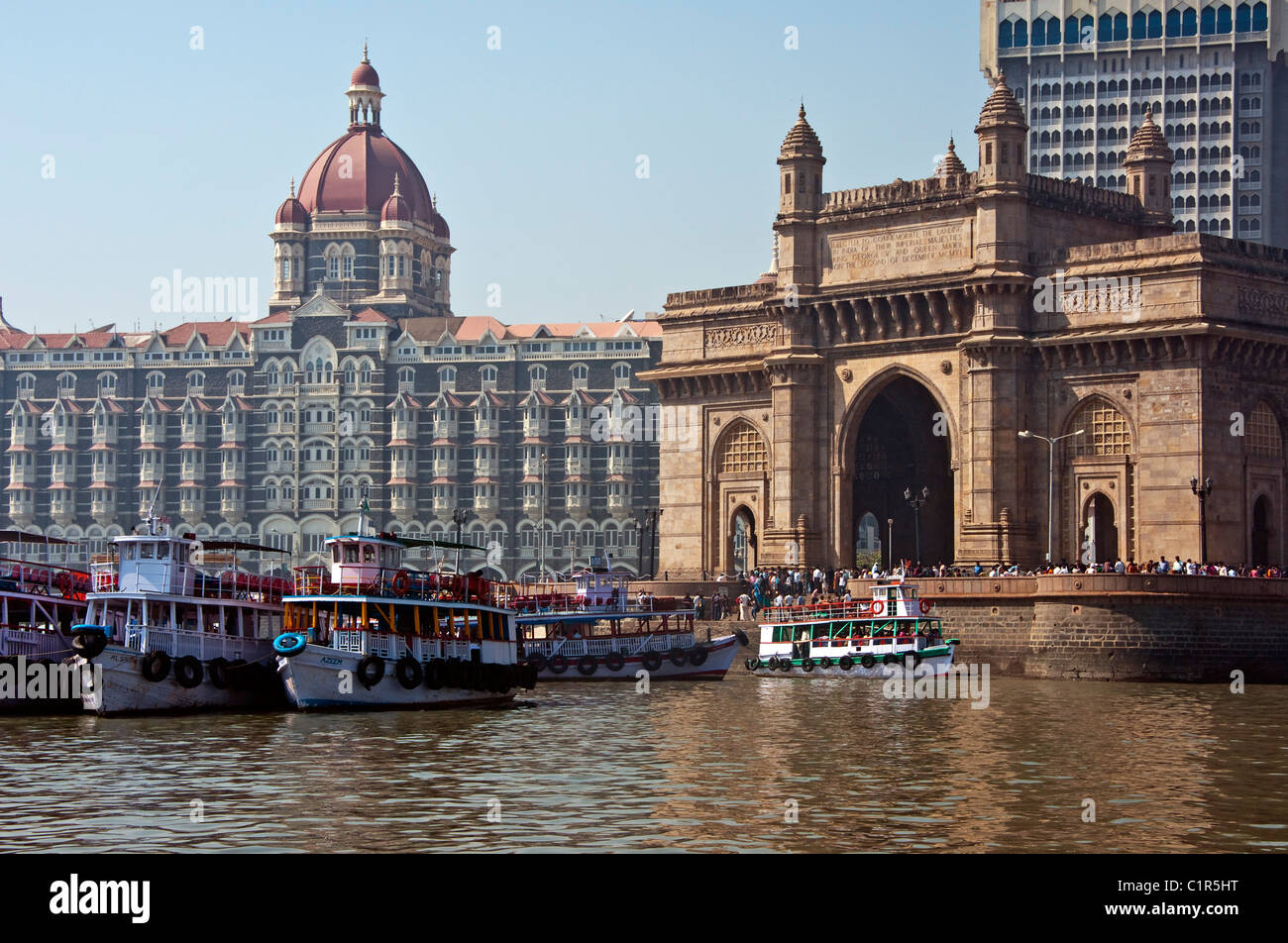 Boats in harbour in front of Mumbai's The Taj Mahal Palace Hotel and Tower at Gate of India built in 1903. Stock Photo