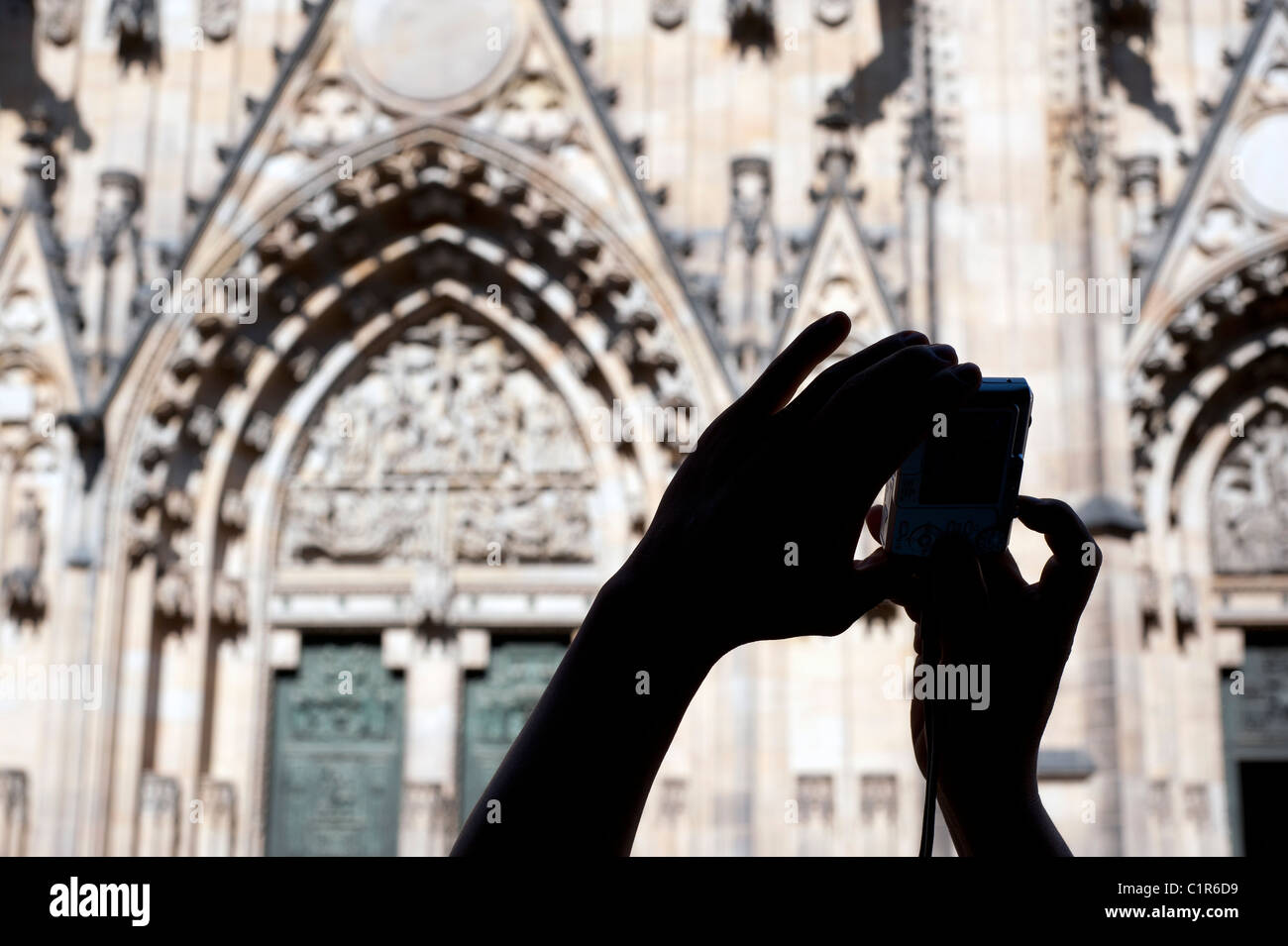 Prague - Hands with a camera in front of cathedral St. Vitus Stock Photo