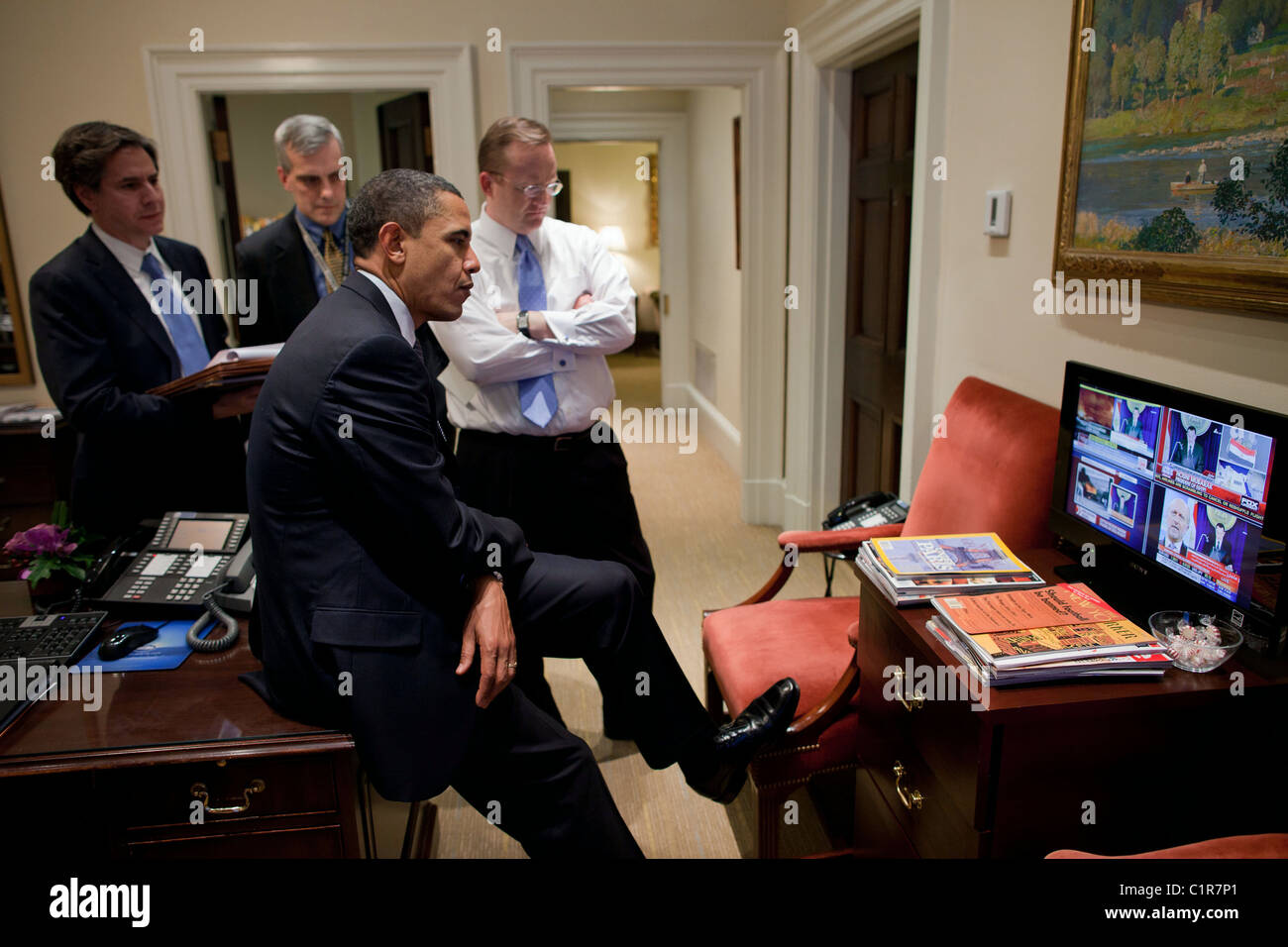 President Barack Obama watches a televised speech by President Hosni Mubarak of Egypt in the Outer Oval Office, Jan. 28, 2011. Stock Photo