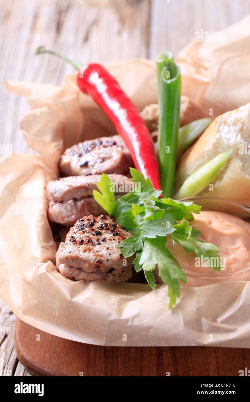 Roast pork tenderloin with bread roll and dipping sauce Stock Photo Alamy