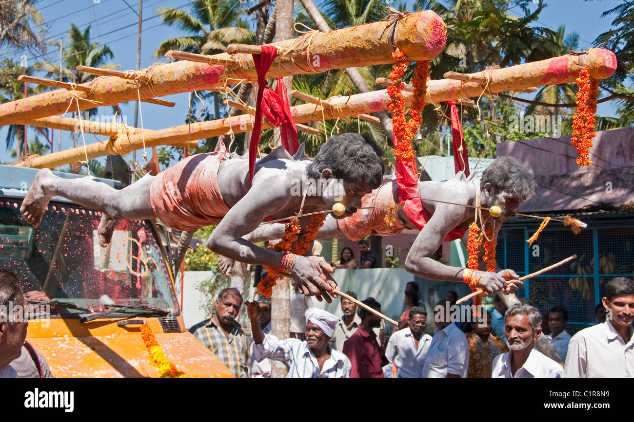 Tamil devotees suspended by fish hooks for Thaipusam Festival at Muruga or Murugan (Hindu god of war) Temple Stock Photo