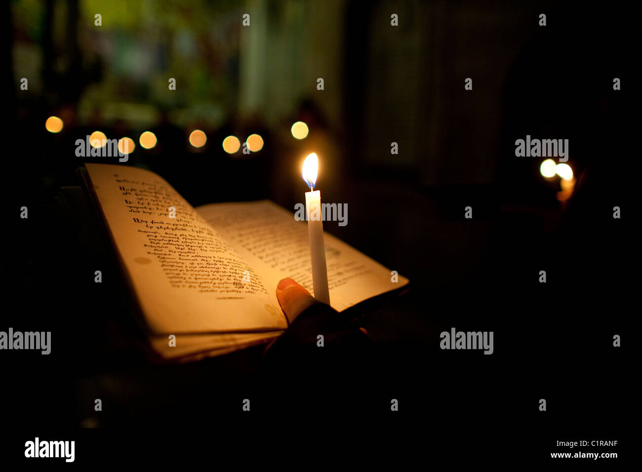 Lighting devotional candles at Calvary, Church of Holy Sepulcher Jerusalem. Stock Photo