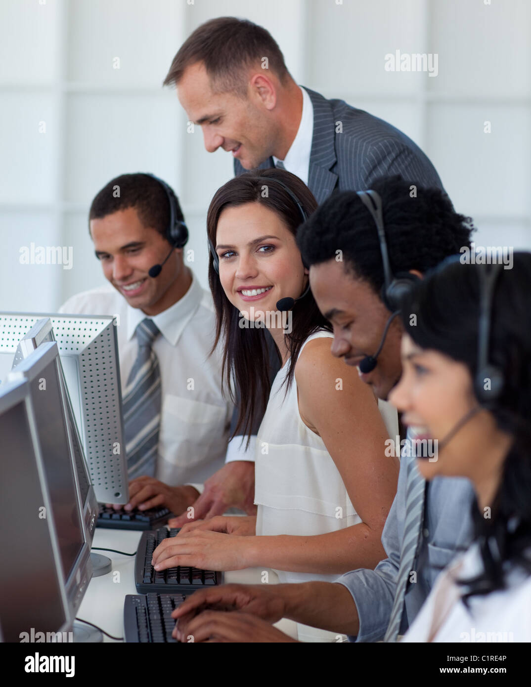 Businesswoman in a call center with her team and manager Stock Photo