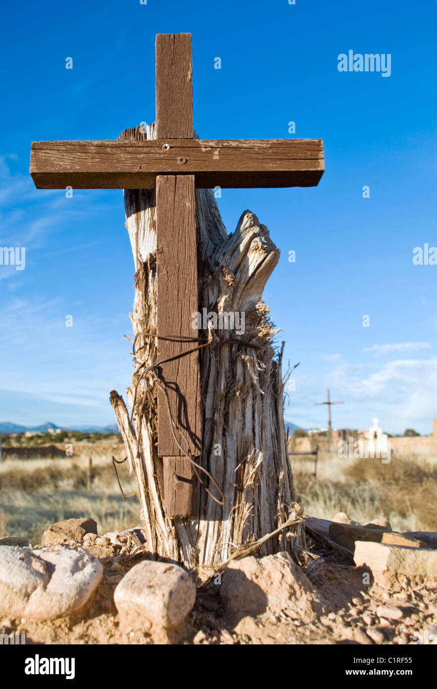 A wooden cross stands at the entrance to a remote cemetery in Galisteo, New Mexico. Stock Photo