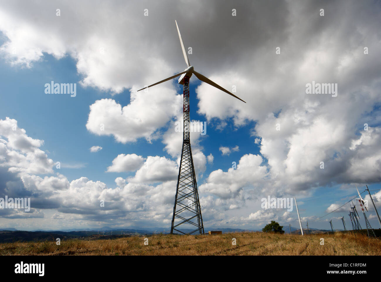 Large trellis wind turbine viewed in dry autumnal field under moody sky Stock Photo