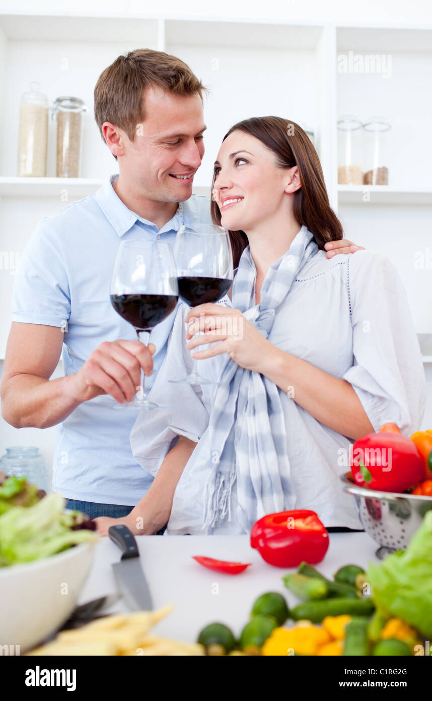 Affectionate couple drinking wine while cooking Stock Photo Alamy