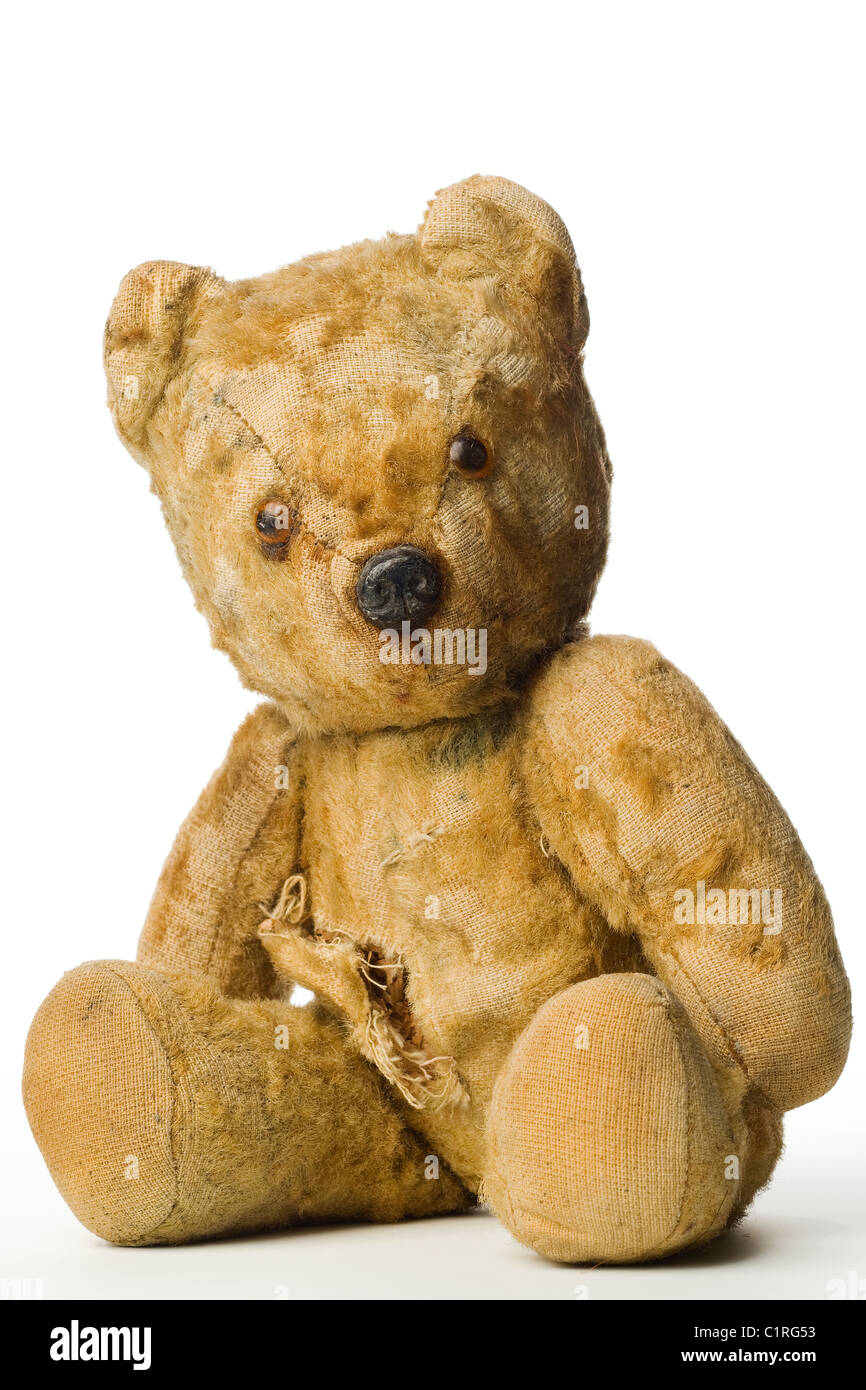 an old and shabby vintage teddy bear on white Stock Photo