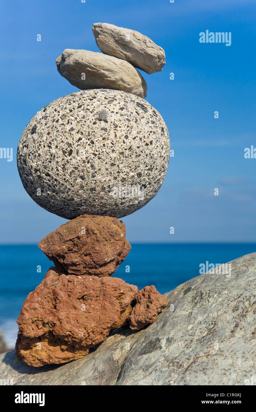 Volcanic Stack Stack of volcanic pebbles by the sea Stock Photo - Alamy