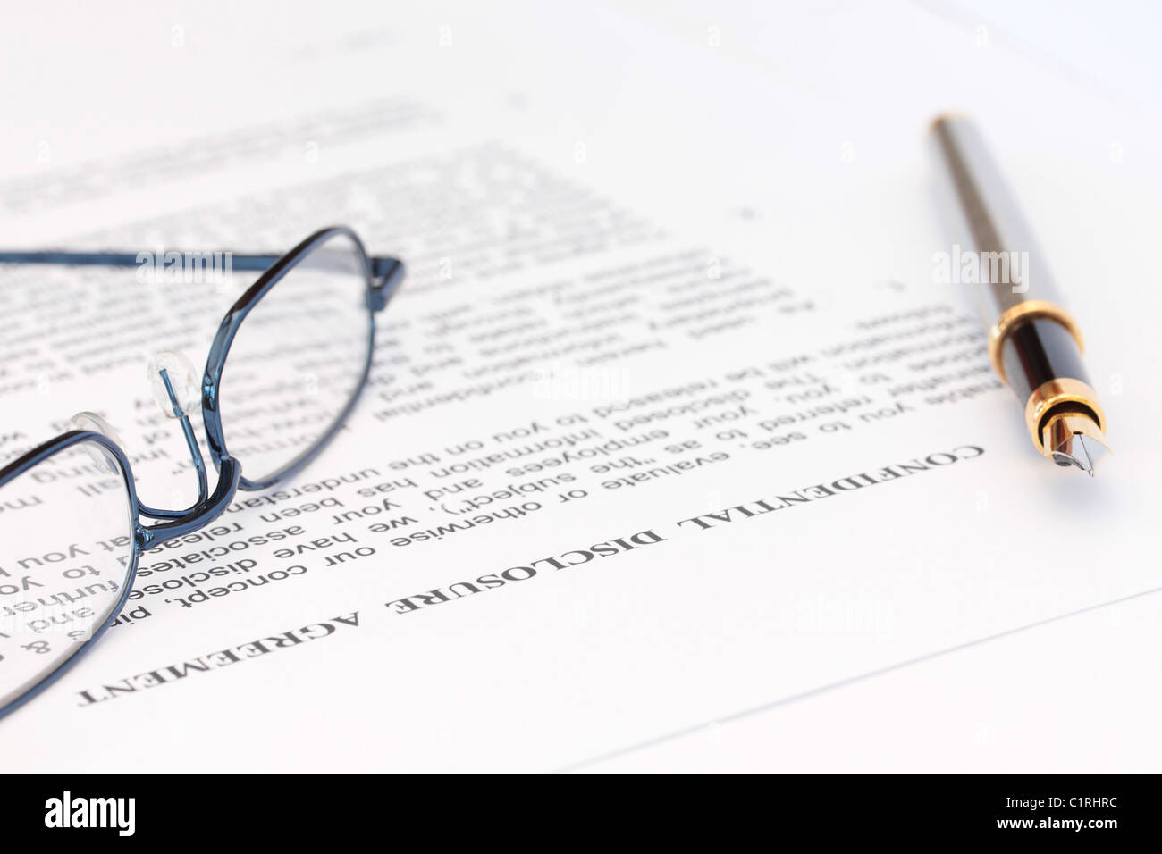 Pen and Spectacles with Disclosure Agreement Stock Photo