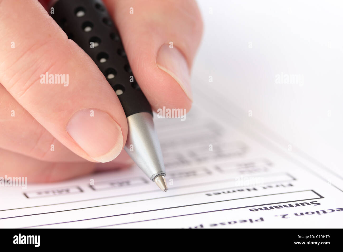 Hand with Pen Completing Form Closeup Stock Photo - Alamy