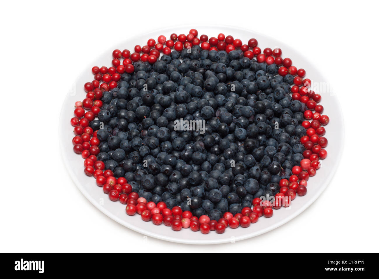 Berries of the whortleberry and cowberries on plate Stock Photo