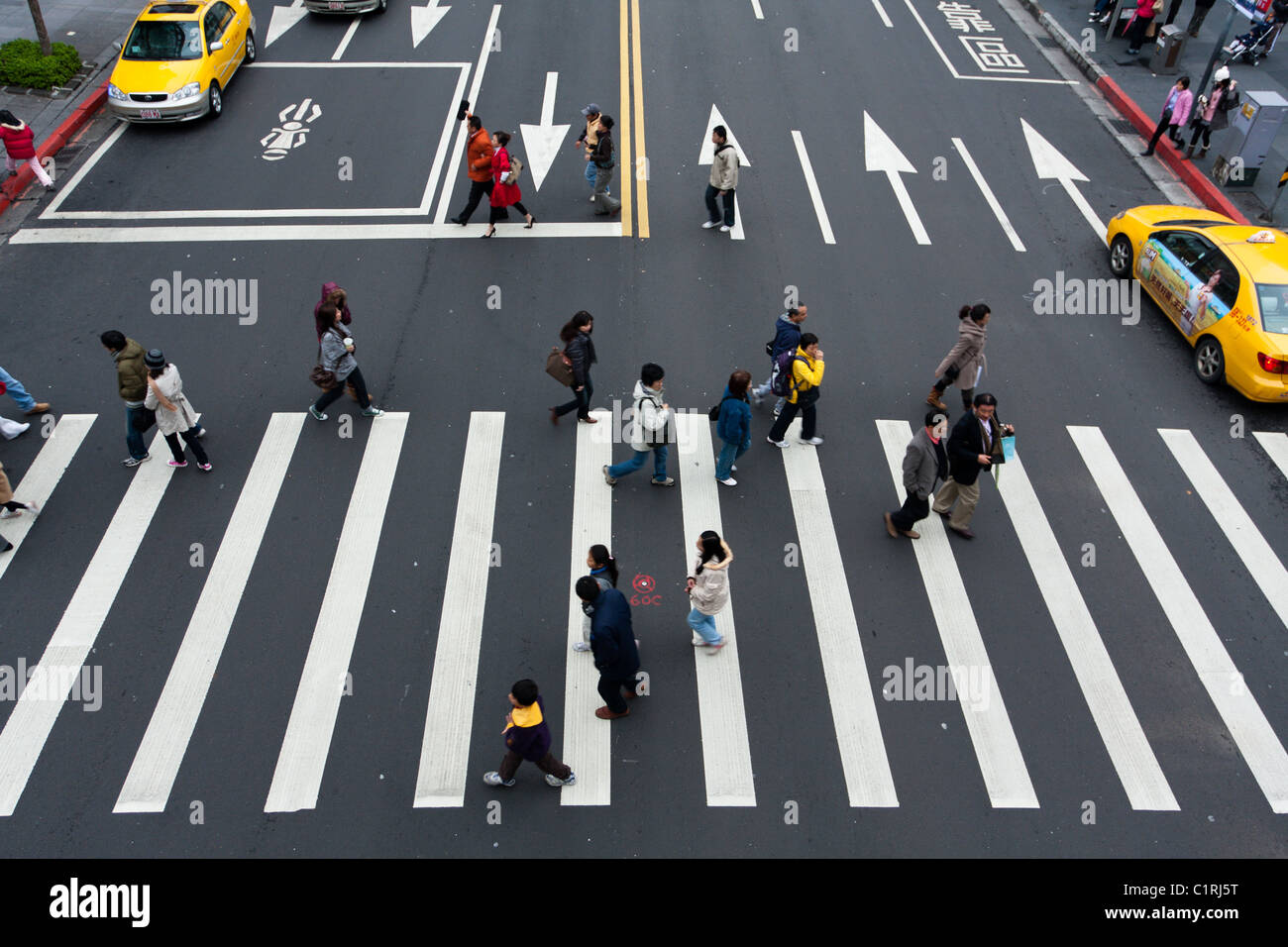 People walking and crossing street crosswalk at Songshou Road, Xinyi ...