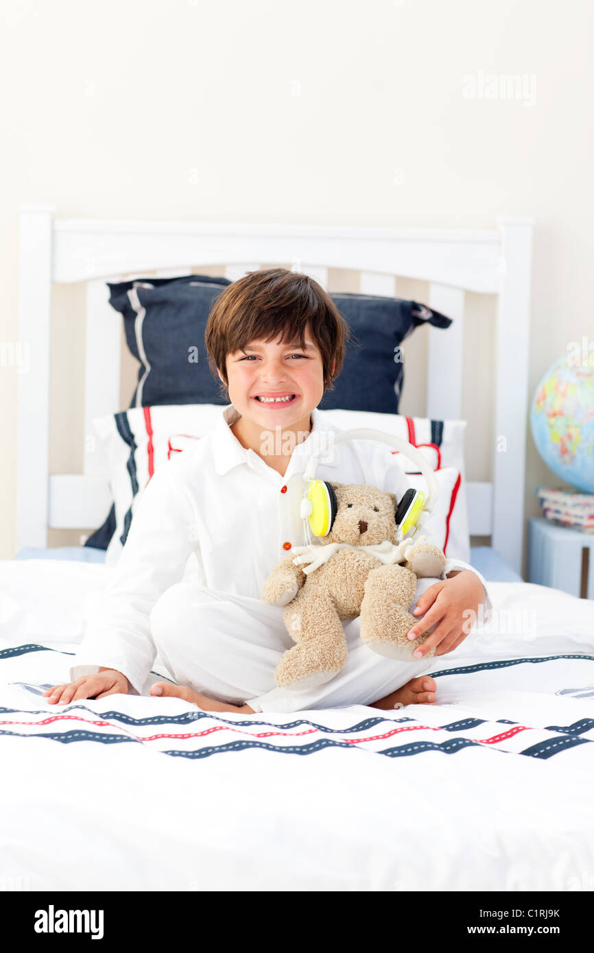 Smiling little boy playing with a teddy bear Stock Photo - Alamy