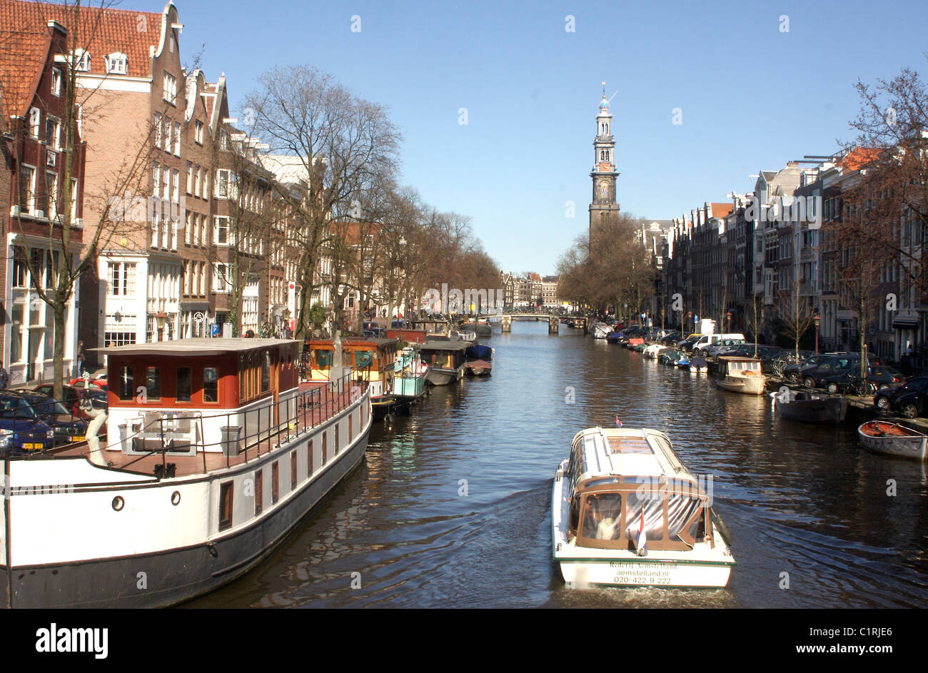 View along the Prinsengracht canal to the Westerkerk church in Amsterdam Stock Photo