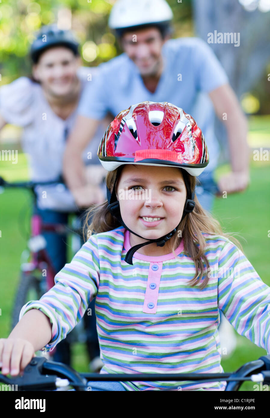 Cute little girl riding a bike Stock Photo Alamy