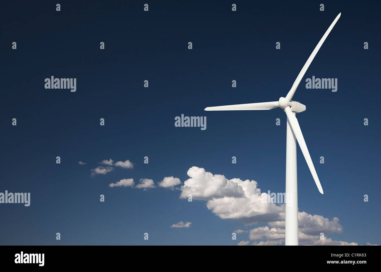Single Wind Turbine Over Dramatic Blue Sky and Clouds Stock Photo - Alamy