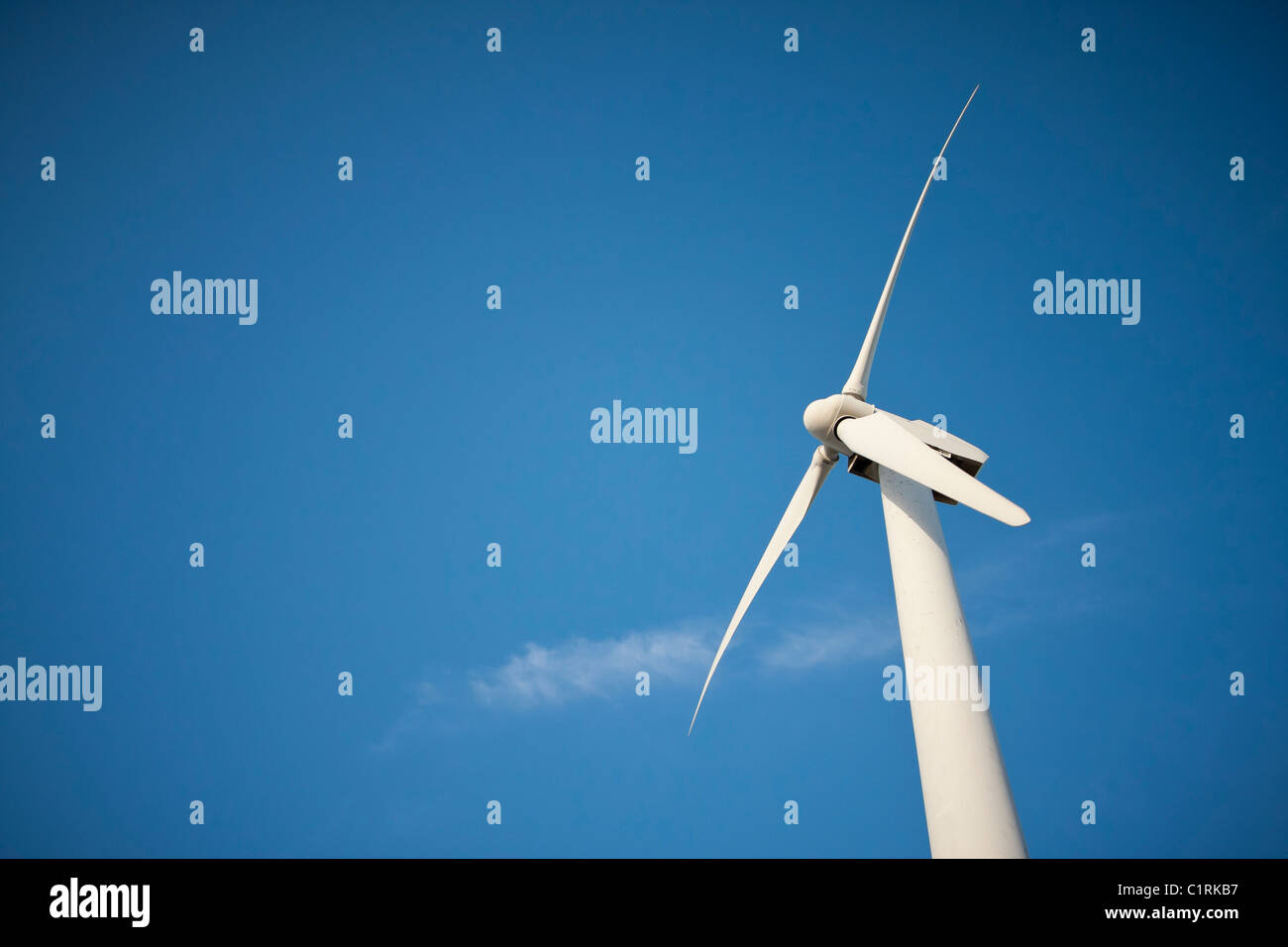 Single Wind Turbine Over Dramatic Blue Sky and Clouds Stock Photo - Alamy