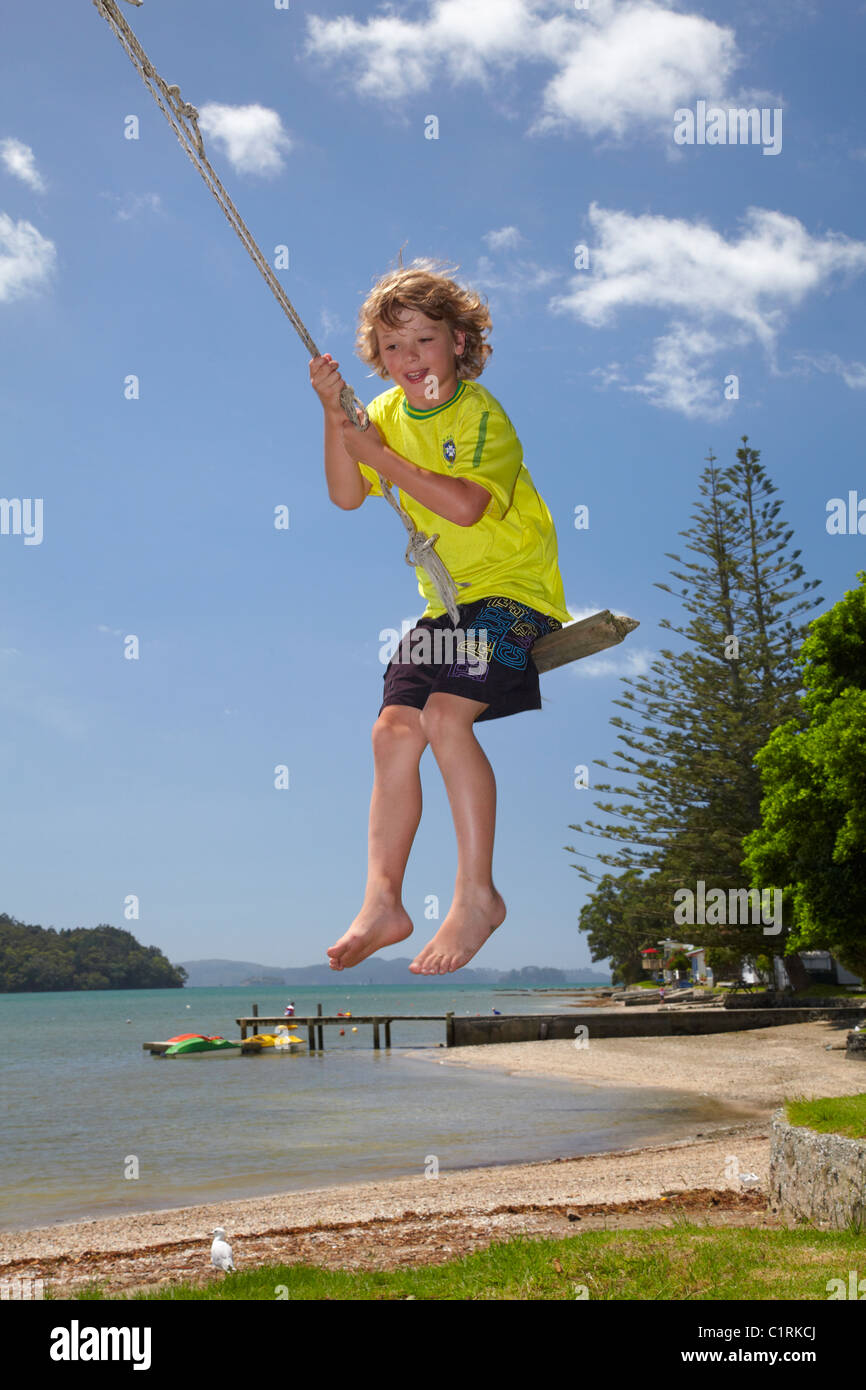 Young boy on rope swing, Sandspit, near Warkworth, Auckland Region