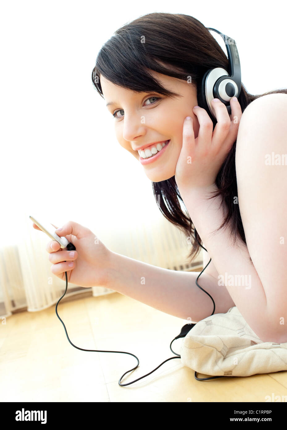 Positive teenager listen to music lying on the floor Stock Photo - Alamy