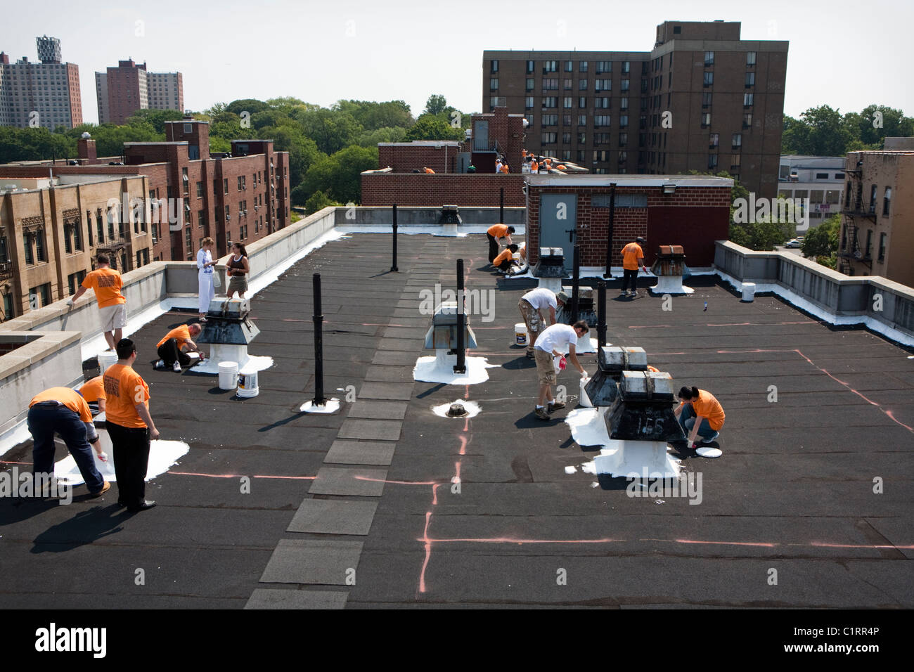 Volunteers paint Bronx, NY rooftop with specialized coating material