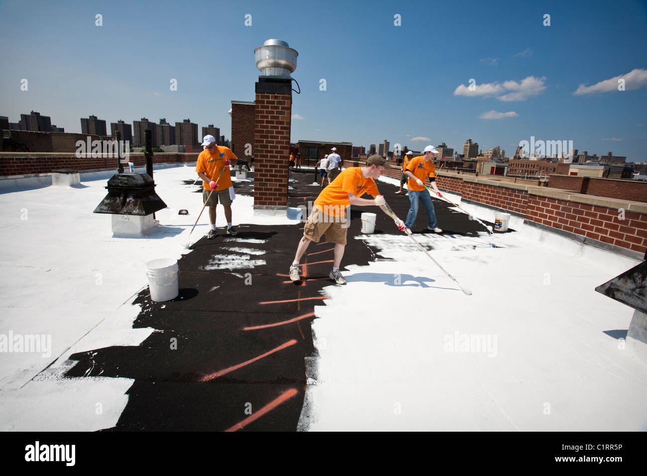 Volunteers paint Bronx, NY rooftop with specialized coating material