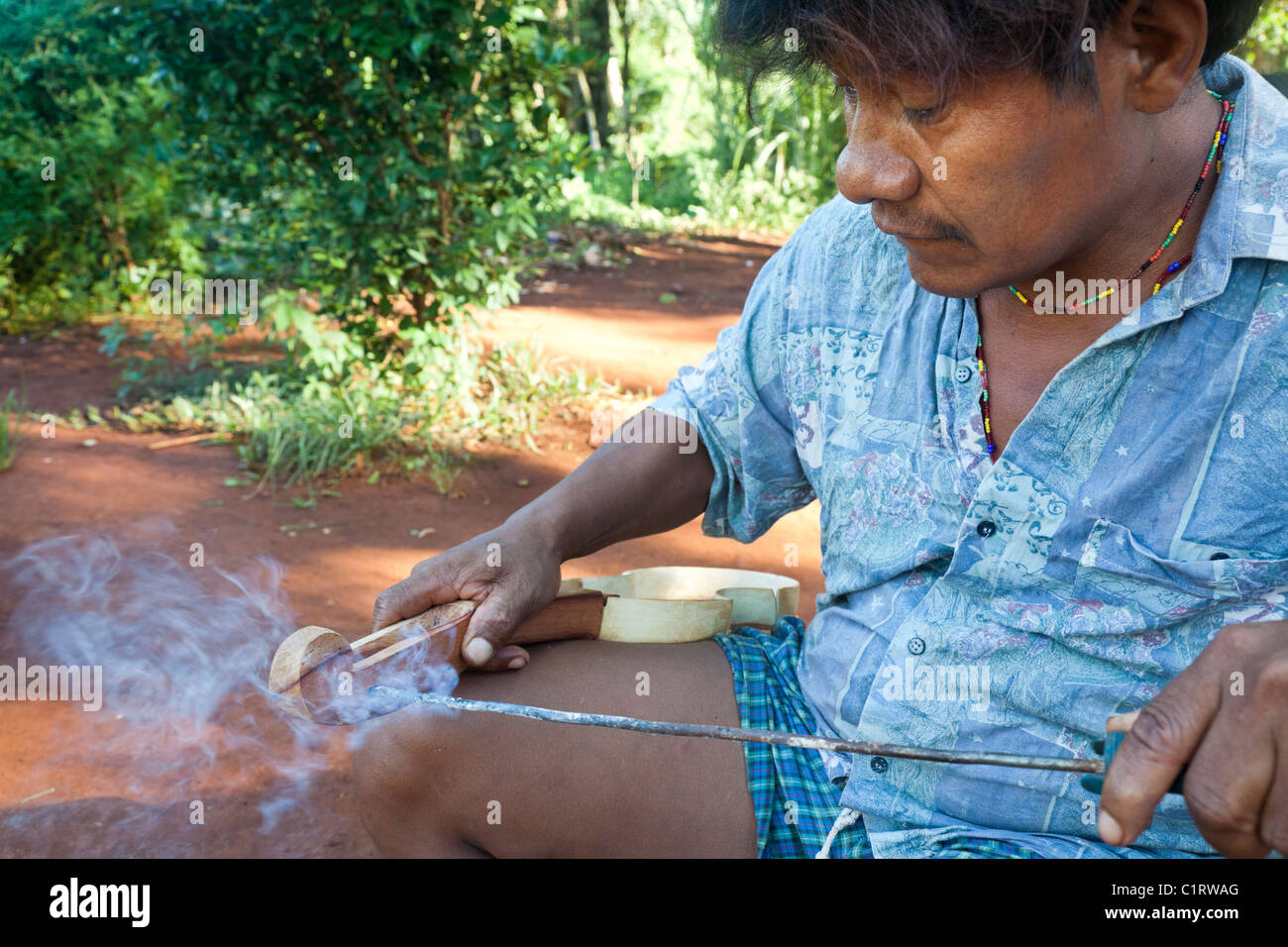 Angel Morinigo, an Mbya Guarani craftsman and musician, hand-building a Guarani 3-string violin (rabe). Stock Photo