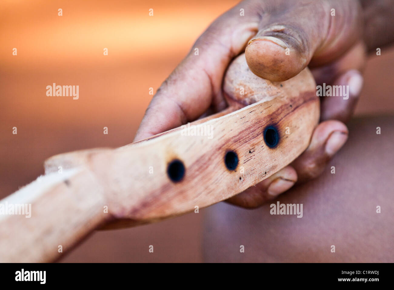 Angel Morinigo, an Mbya Guarani craftsman and musician, hand-building a Guarani 3-string violin (rabe). Stock Photo