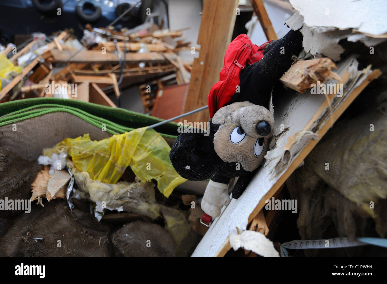 A child's Mickey Mouse doll lies in tatters among debris in Ofunato, Japan, following the March 2011 earthquake + tsunami. Stock Photo