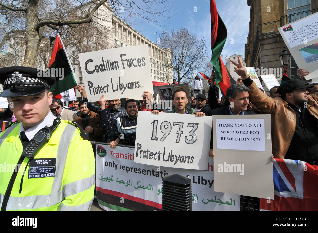 Libyan anti Gaddafi protest outside Downing Street waving flags chanting 'Thank you UK' Stock Photo