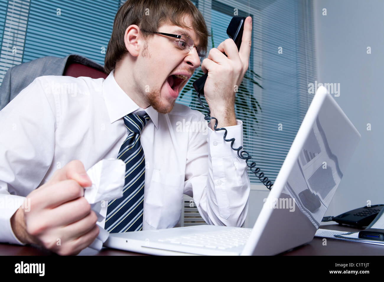 Image of annoyed boss losing his temper and screaming into phone receiver Stock Photo Alamy