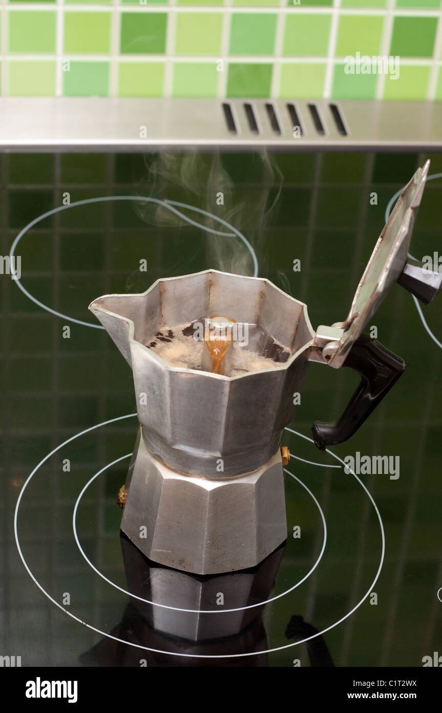 Coffee-maker boils coffee on black ceramic lash Stock Photo