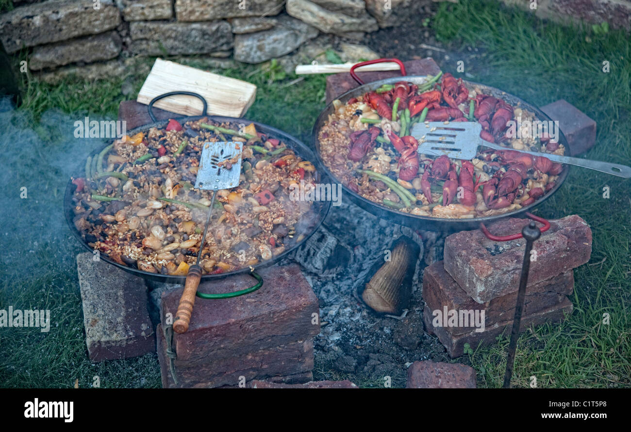 Paella cooking on an open fire Stock Photo