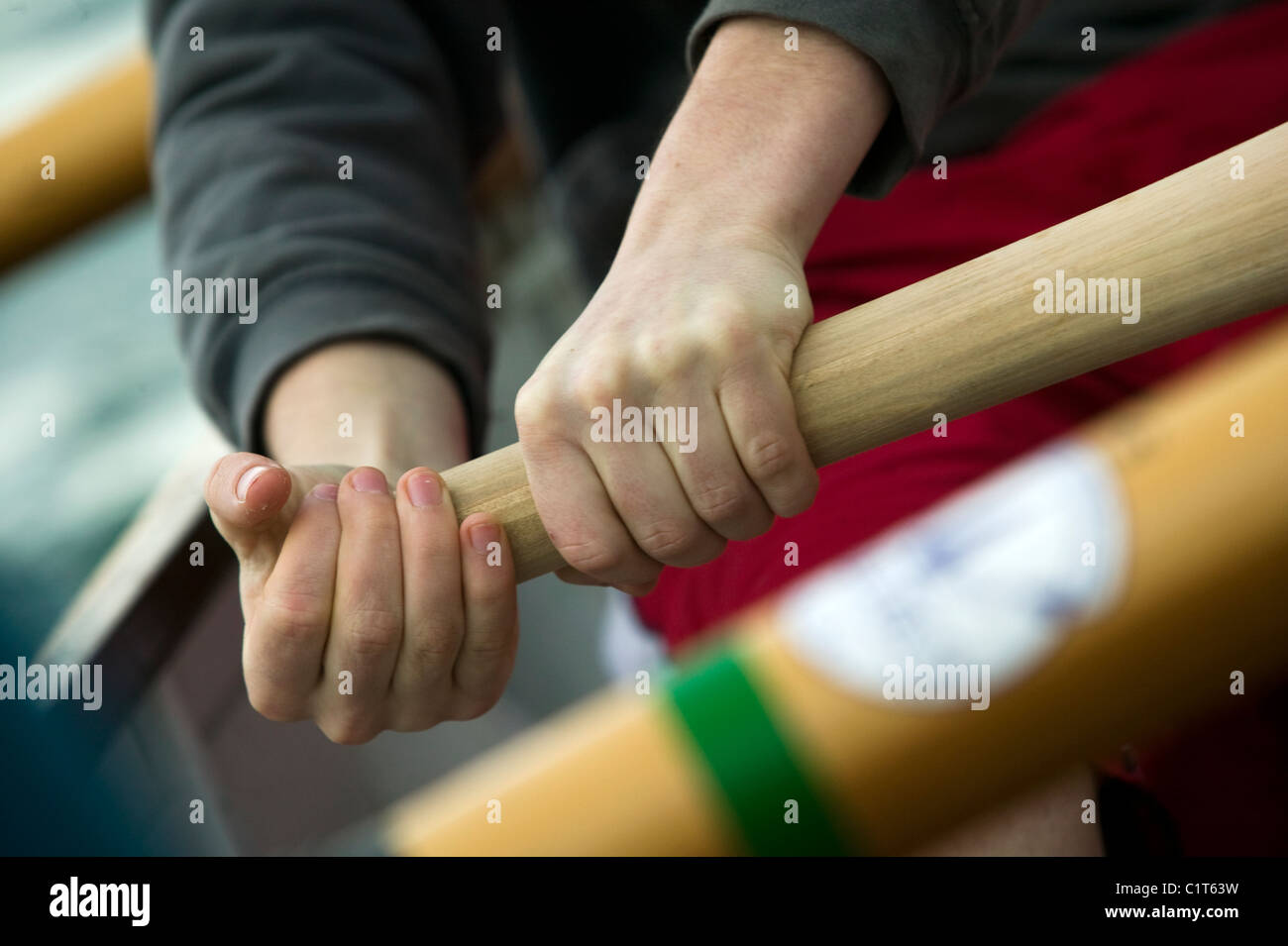 The hands of a rower on the oar of a Cornish pilot gig Stock Photo