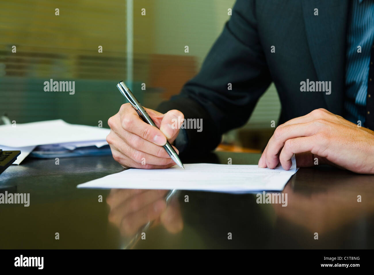 Executive signing paperwork, cropped Stock Photo - Alamy