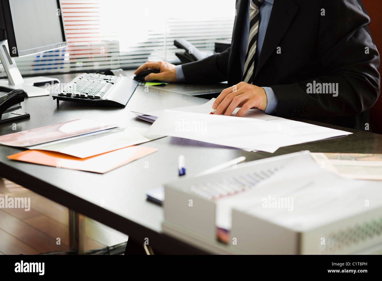 Executive working in office, cropped Stock Photo