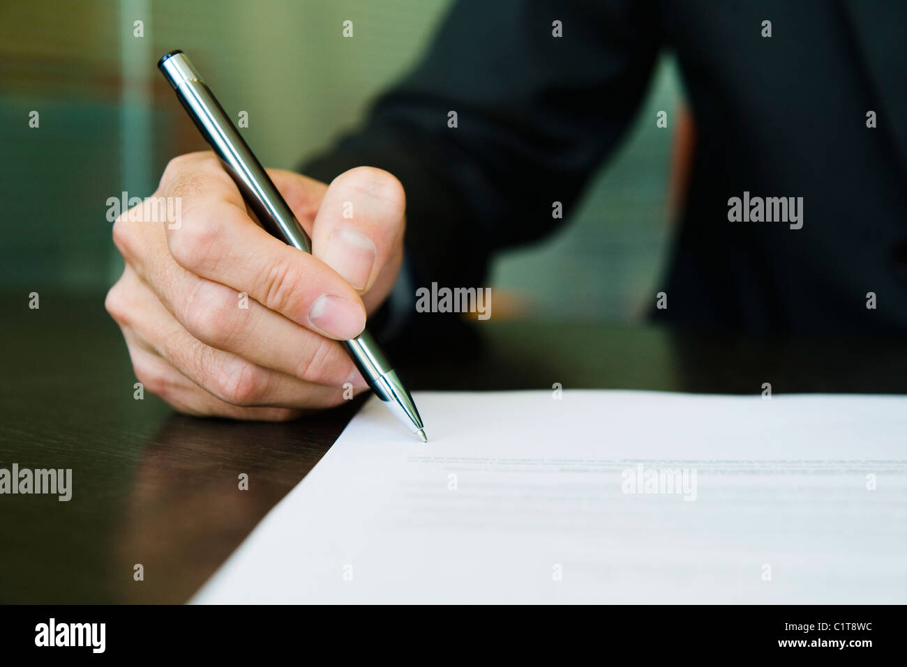 Businessman signing paperwork, cropped Stock Photo