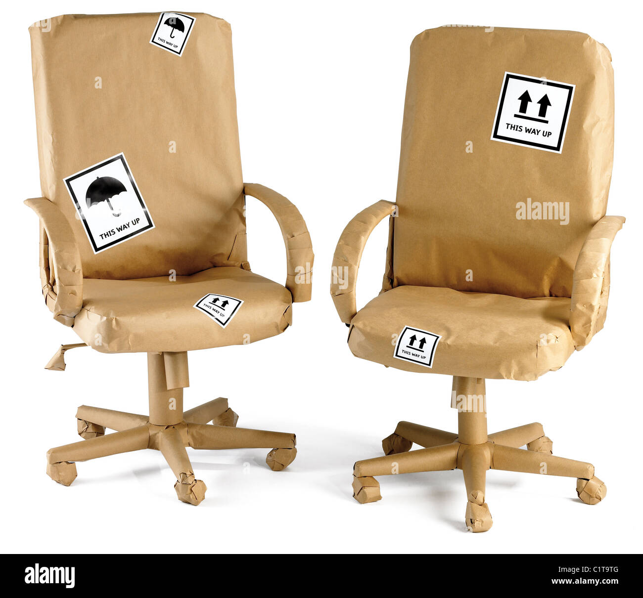 office chairs wrapped up in brown paper ready for a move isolated on a white background Stock Photo