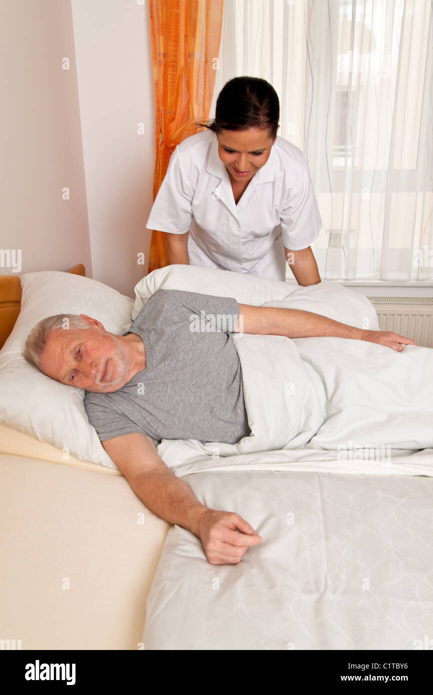Nurse in aged care for the elderly in nursing homes Stock Photo