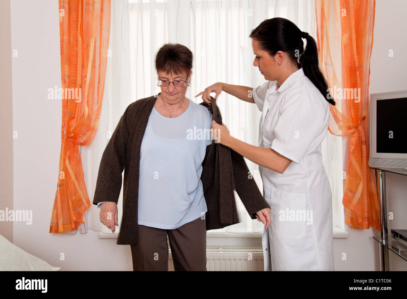 Nurse in aged care for the elderly in nursing homes Stock Photo