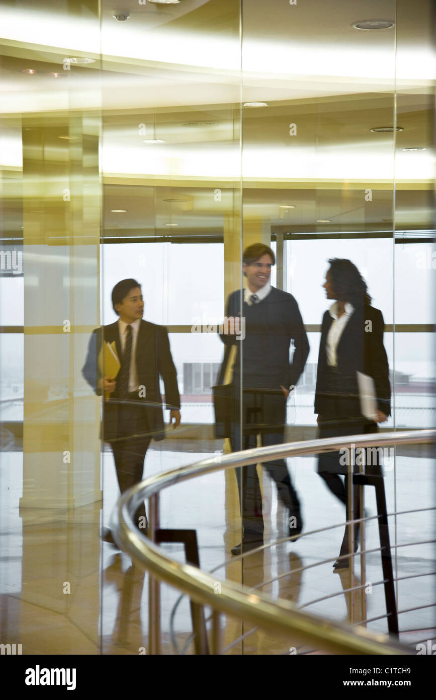Executives walking and talking together Stock Photo - Alamy
