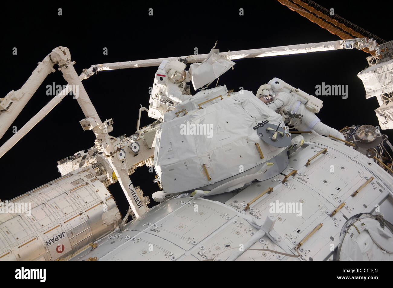 Astronauts participate in a session of extravehicular activity. Stock Photo