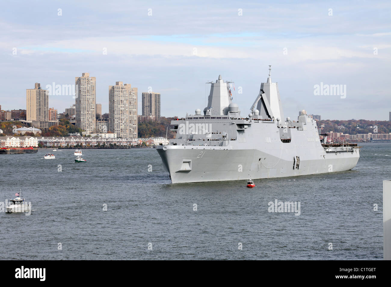 Marines and sailors man the rails of the USS New York. Stock Photo
