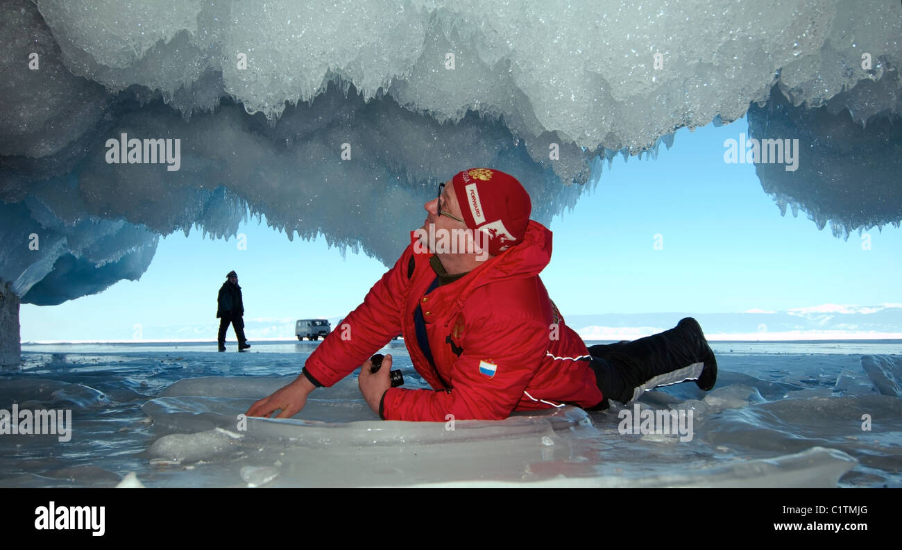 Man inside the ice cave. Olkhon island, Baikal lake, Siberia, Russia Stock Photo