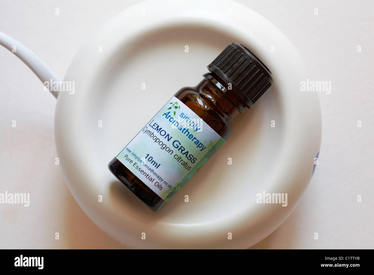 Bottle of Simply Aromatherapy Lemon Grass Pure Essential Oils in Aromatherapy stone Stock Photo