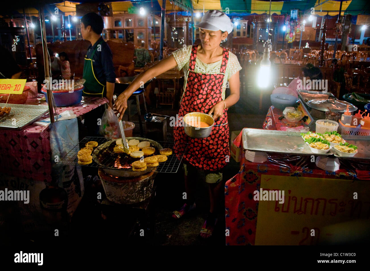 Preparing a taro patty in a Khon Kaen night market. Stock Photo