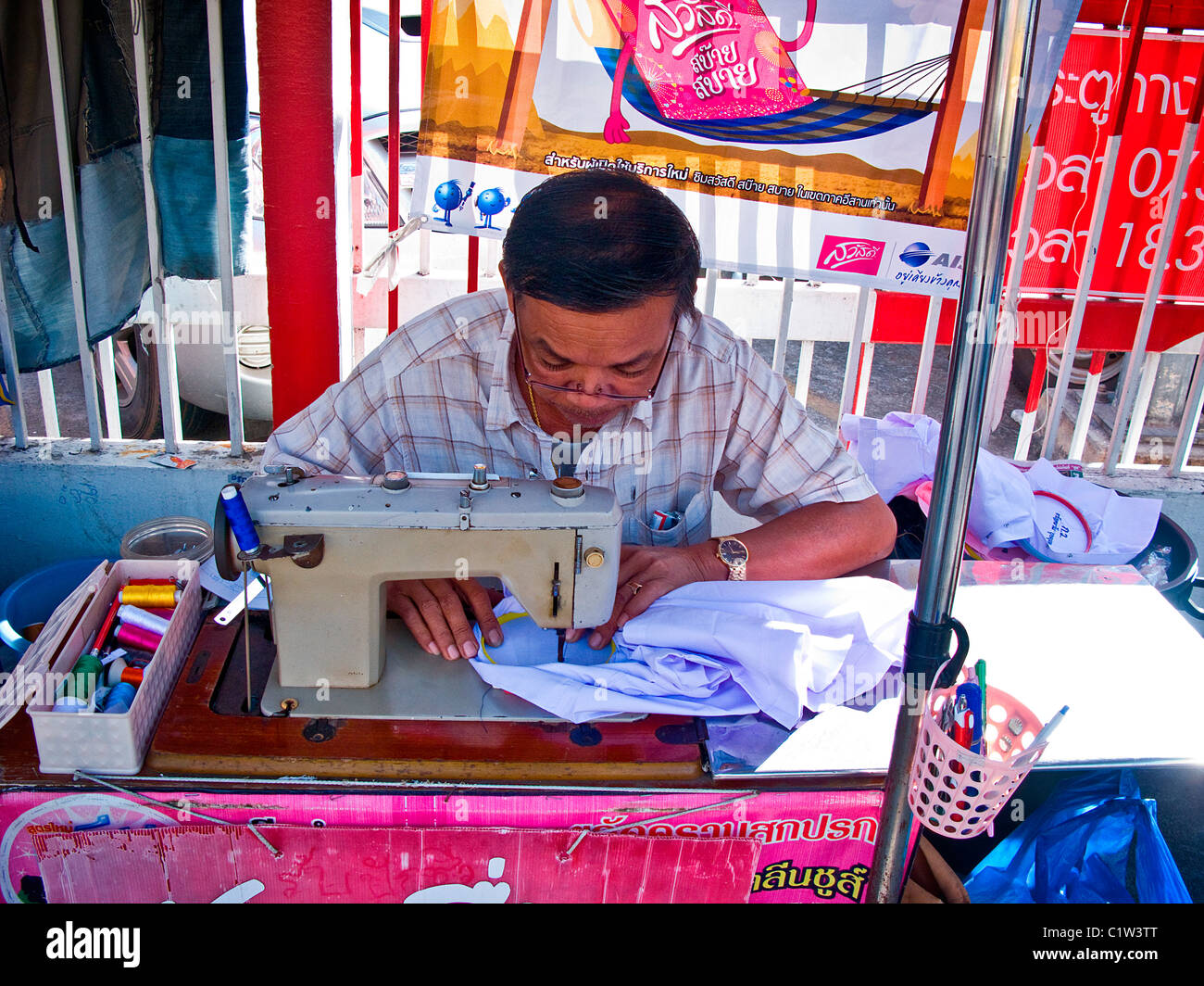 Thailand, Khon Kaen, Street tailor working at sewing machine Stock Photo